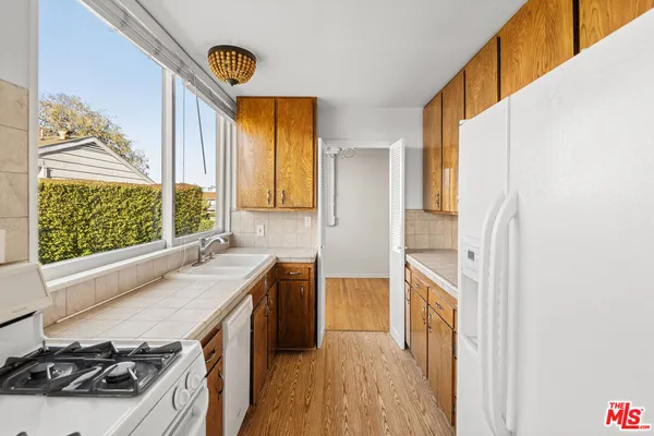 a kitchen with a sink a stove and a refrigerator