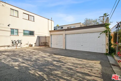 a view of a parking space in front of a house