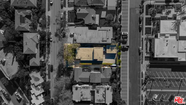 an aerial view of residential houses with outdoor space