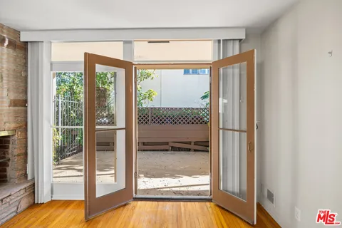 a view of a bathtub in a room with a glass door