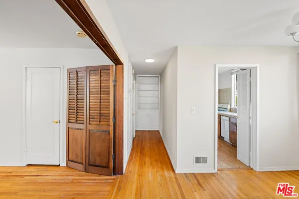 a view of a room with wooden floor and entryway