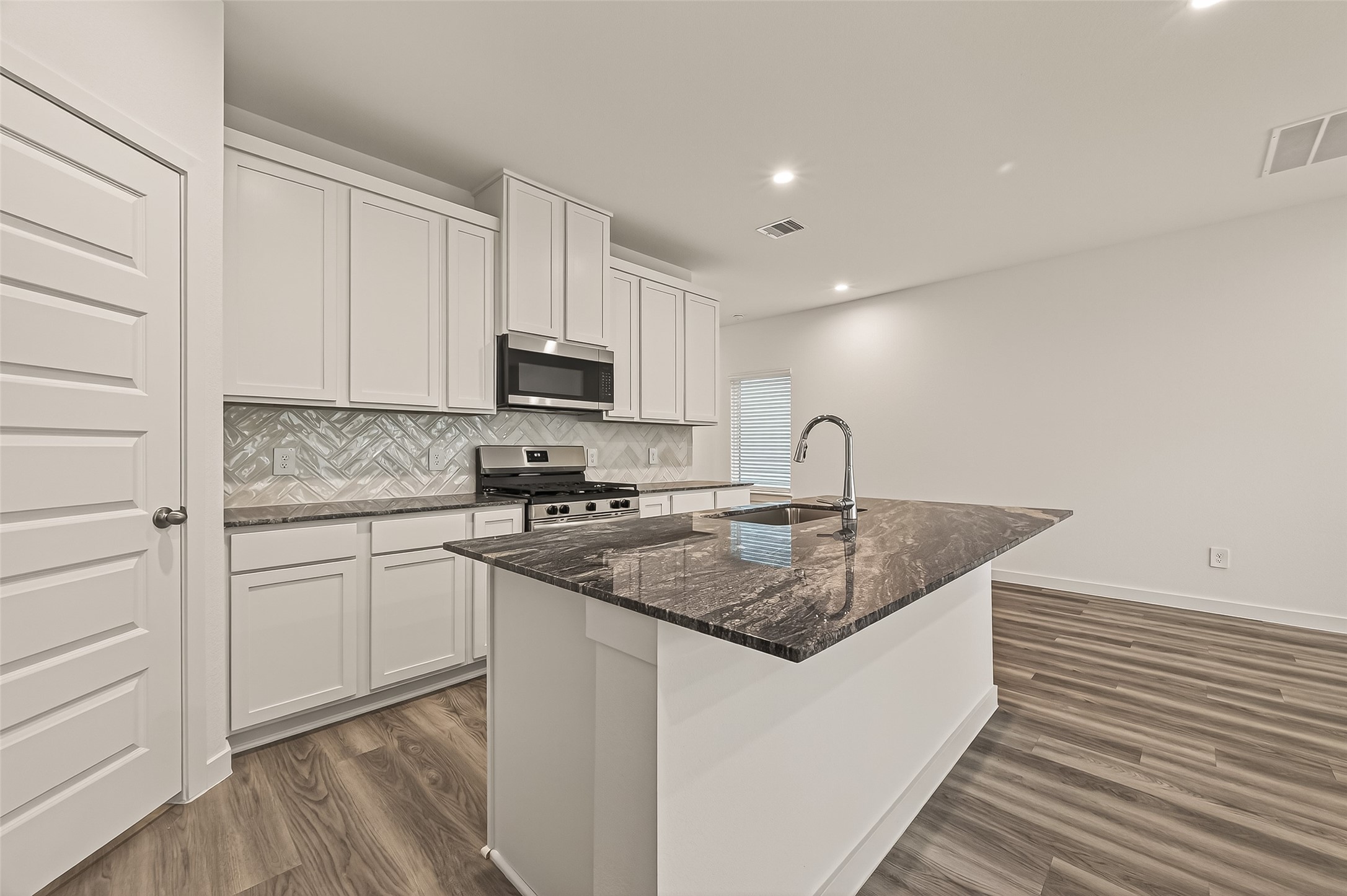 2826 Lisburn Ter Lane Houston, TX 77051 - Photo 2 of 18 a kitchen with sink a microwave and cabinets