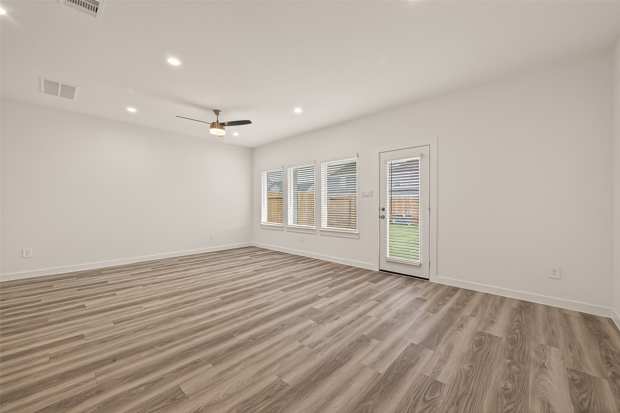 2826 Lisburn Ter Lane Houston, TX 77051 - Photo 6 of 18 a view of an empty room with a window and wooden floor