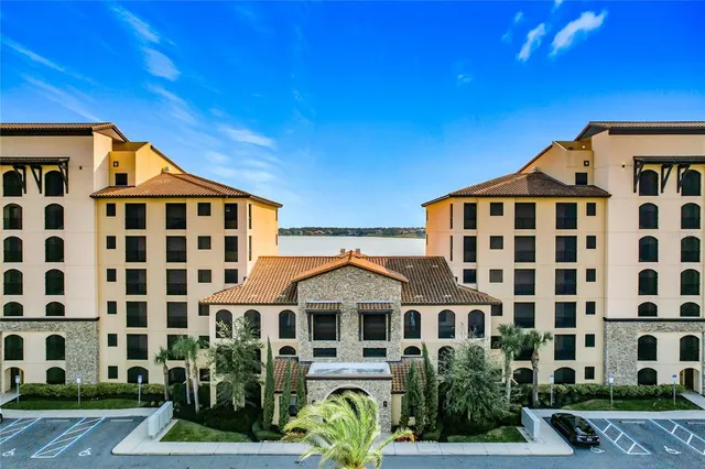 a front view of a residential apartment building with a yard