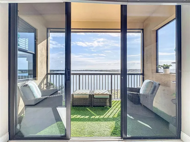 a bedroom with a bed and a balcony view