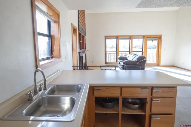 a kitchen with a sink and large window