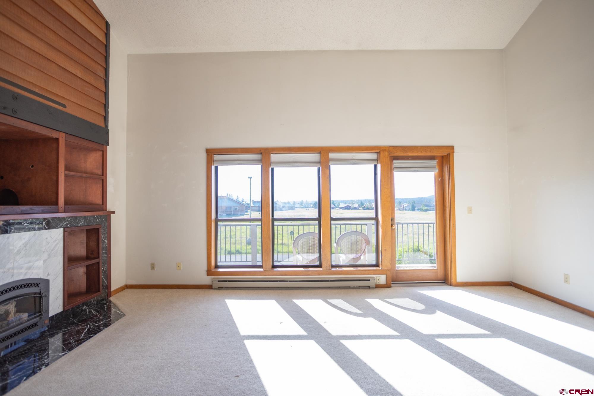 164 Valley View Drive, Unit 3218 Pagosa Springs, CO 81147 - Photo 13 of 39 a view of an empty room with a fireplace and a window