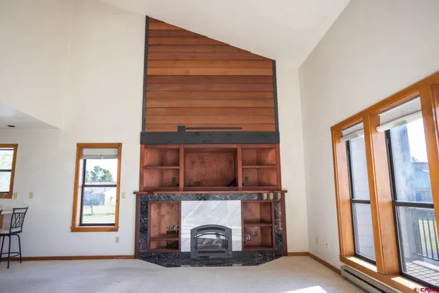 a living room with a fireplace furniture and a window