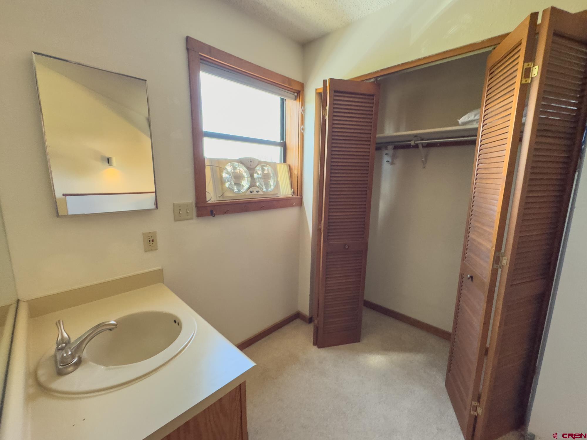 164 Valley View Drive, Unit 3218 Pagosa Springs, CO 81147 - Photo 25 of 39 a bathroom with a sink a mirror and vanity