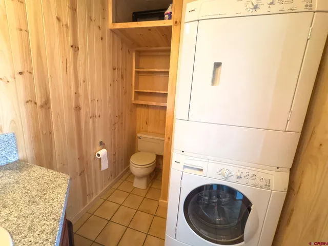 a spacious bathroom with a granite countertop sink a toilet and shower