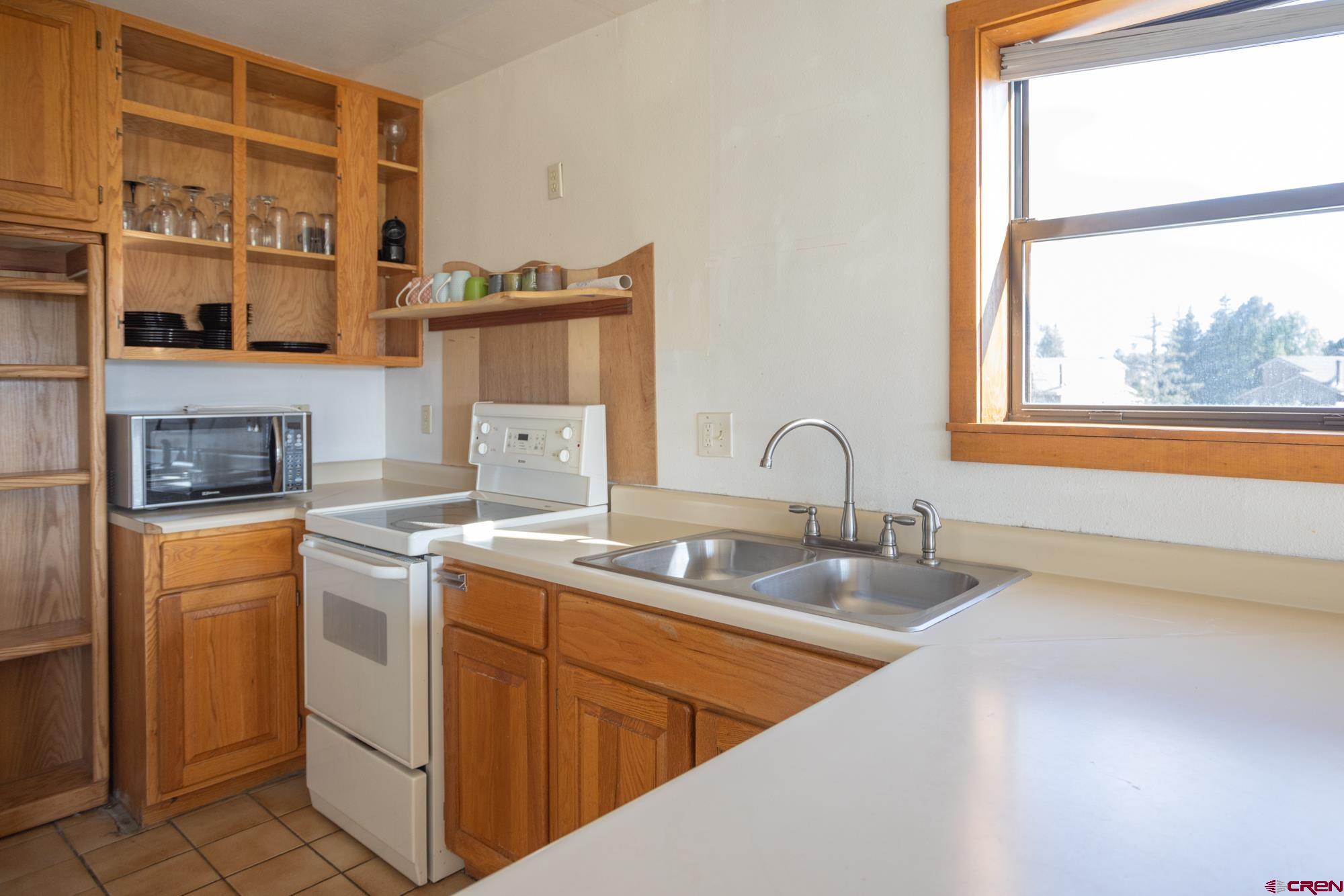 164 Valley View Drive, Unit 3218 Pagosa Springs, CO 81147 - Photo 9 of 39 a kitchen that has a sink and a stove in it