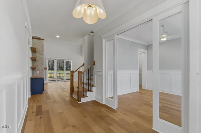 a view of an empty room with a fireplace and a window