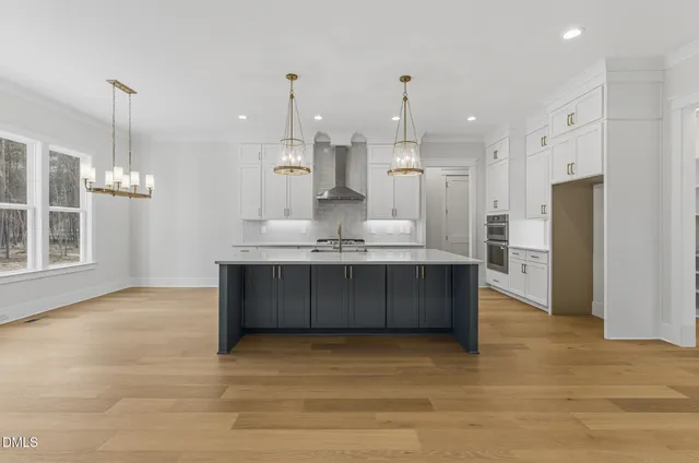 a view of a room with wooden floor and iron stairs