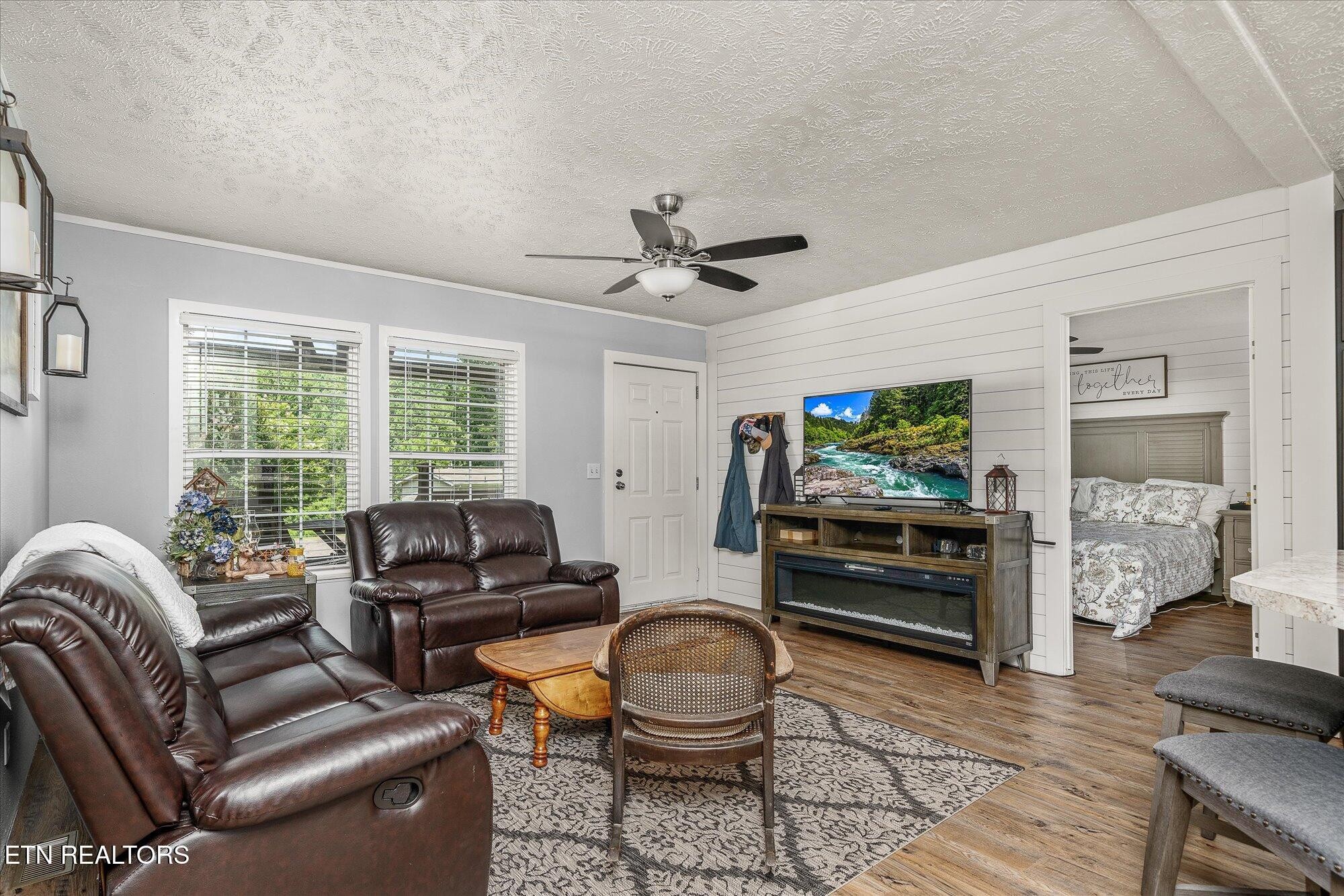 20292025 Shiloh Road Decatur, TN 37322 - Photo 53 of 60 a living room with furniture a flat screen tv and a large window