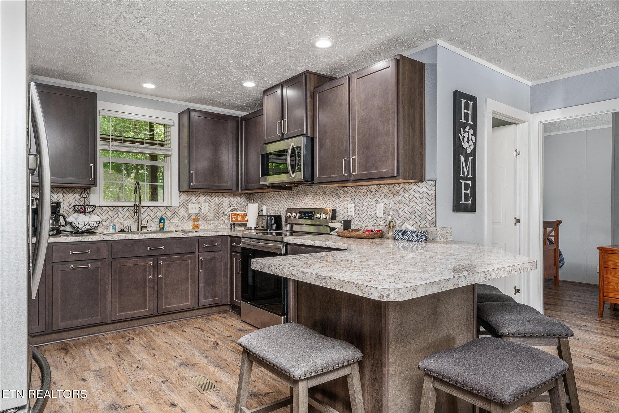20292025 Shiloh Road Decatur, TN 37322 - Photo 59 of 60 a kitchen with a stove a sink and a refrigerator