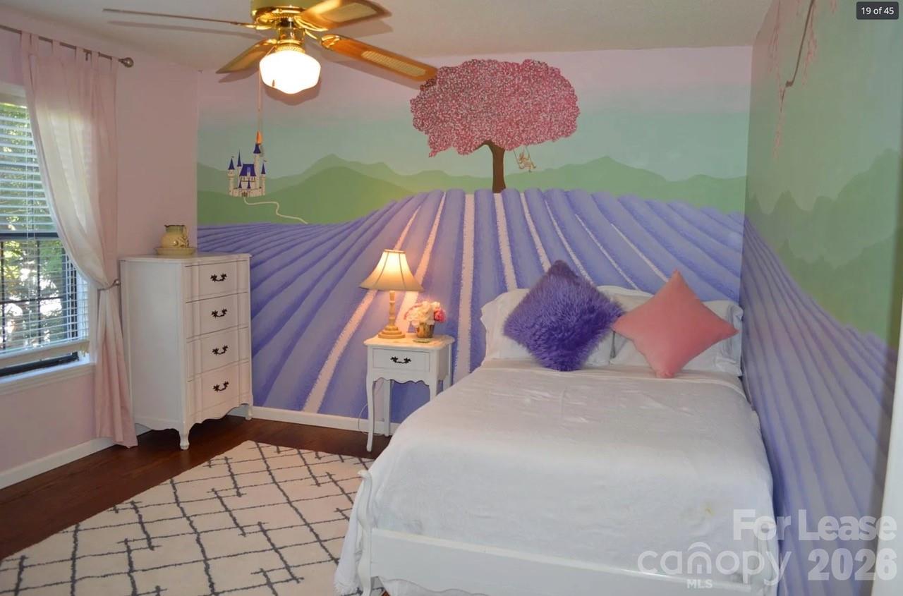 4167 Greenview Court Fort Mill, SC 29708 - Photo 9 of 16 a bedroom with a bed and a chandelier