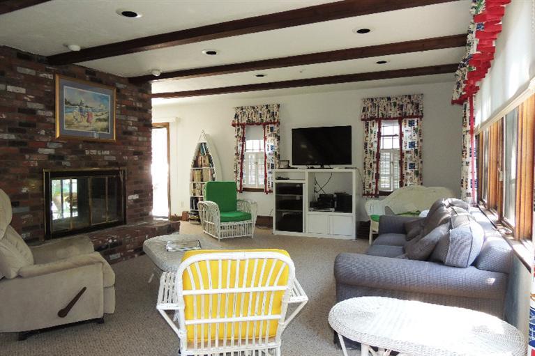 23 Shore Rd Extension West Harwich, MA 02671 - Photo 4 of 24 a living room with furniture a flat screen tv and a large window