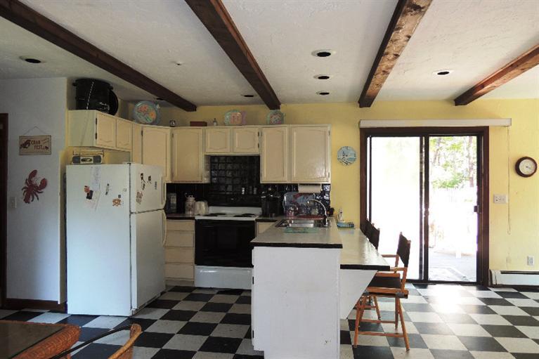 23 Shore Rd Extension West Harwich, MA 02671 - Photo 9 of 24 a kitchen with stainless steel appliances a refrigerator sink and cabinets