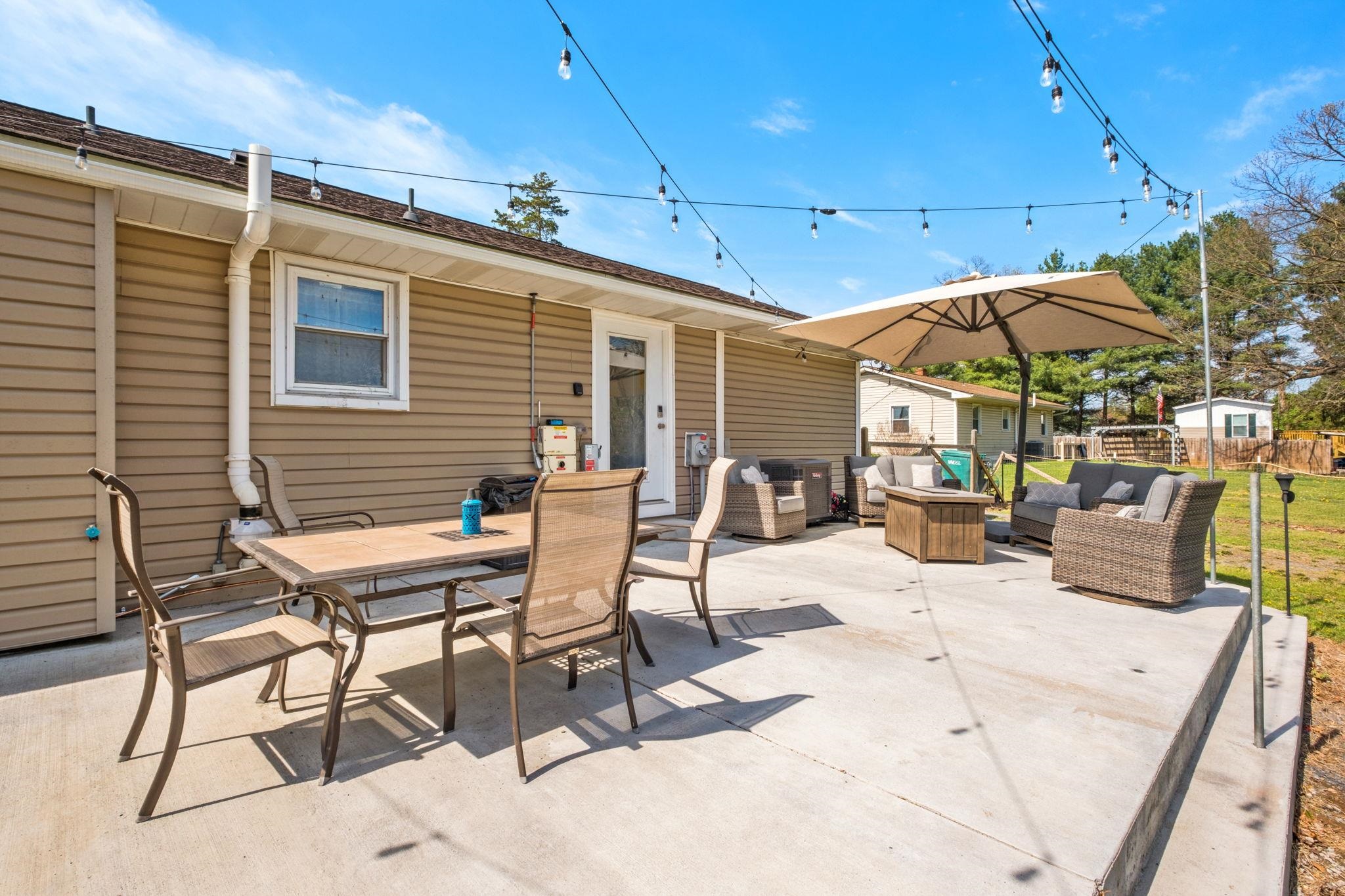 8208 George Wine Road Bridgewater, VA 22812 - Photo 25 of 27 a view of a patio with a table and chairs under an umbrella