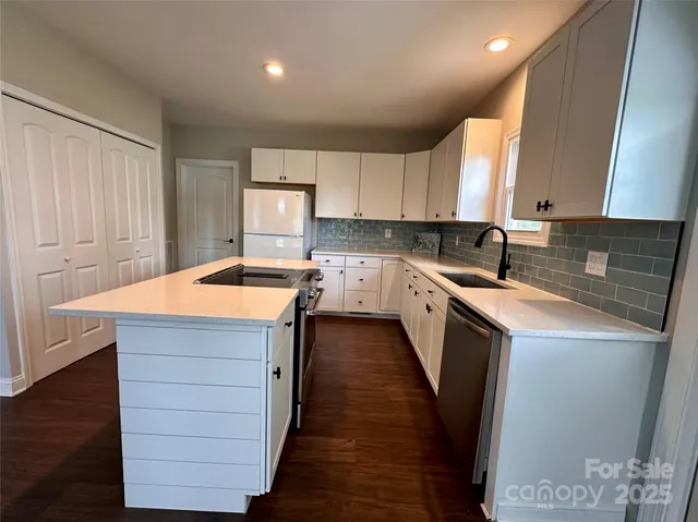 a large kitchen with wooden floor