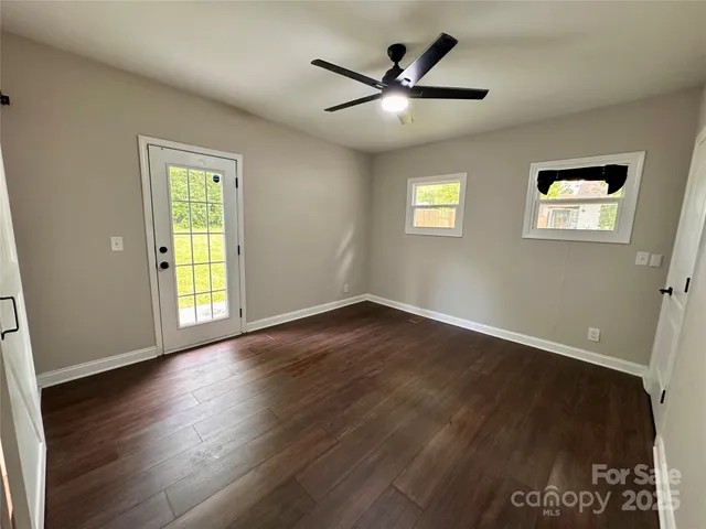 a bathroom with a granite countertop toilet a sink and a mirror