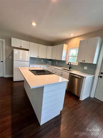 a view of a kitchen with a sink and a stove top oven