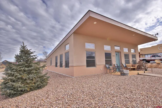a front view of a house with sitting area