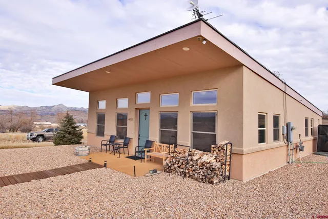 a blue and white umbrella sitting in front of a building