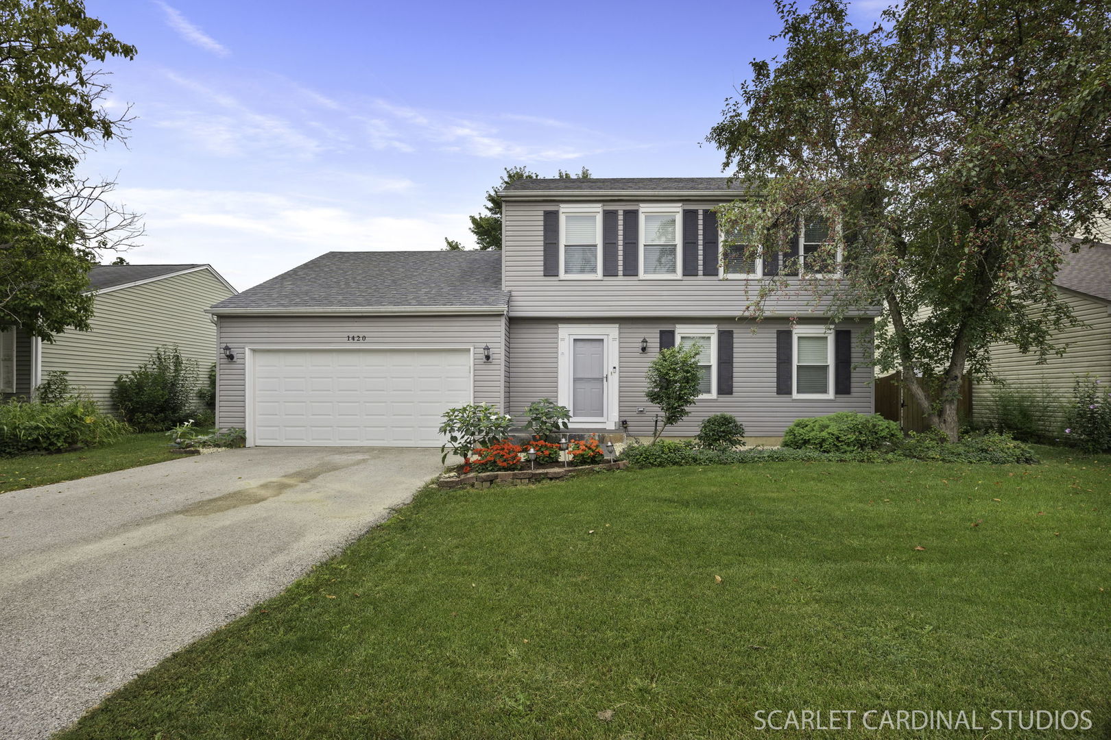 a front view of a house with a garden and porch
