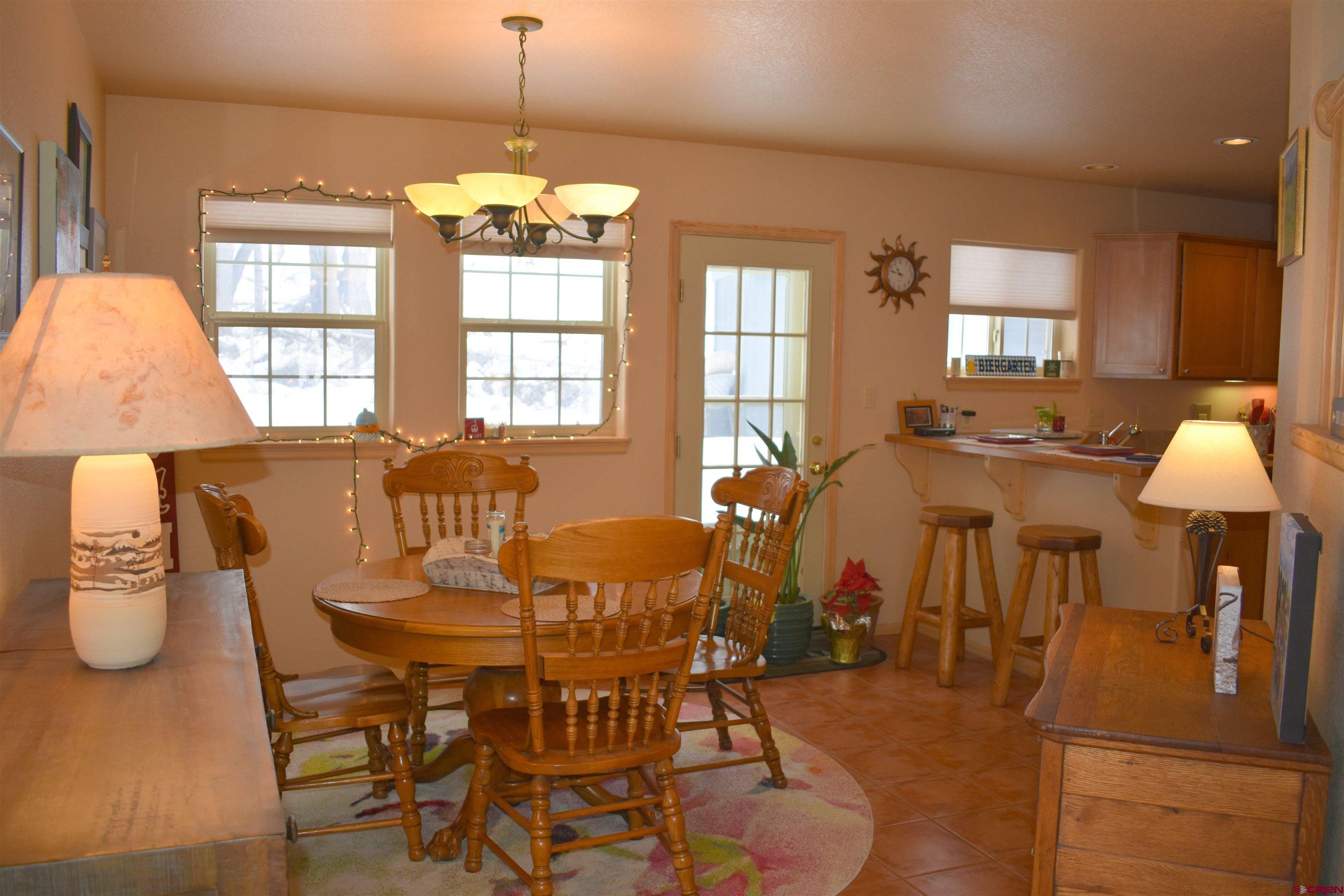 1570 Oak Street Ouray, CO 81427 - Photo 13 of 35 a view of a dining room with furniture and chandelier