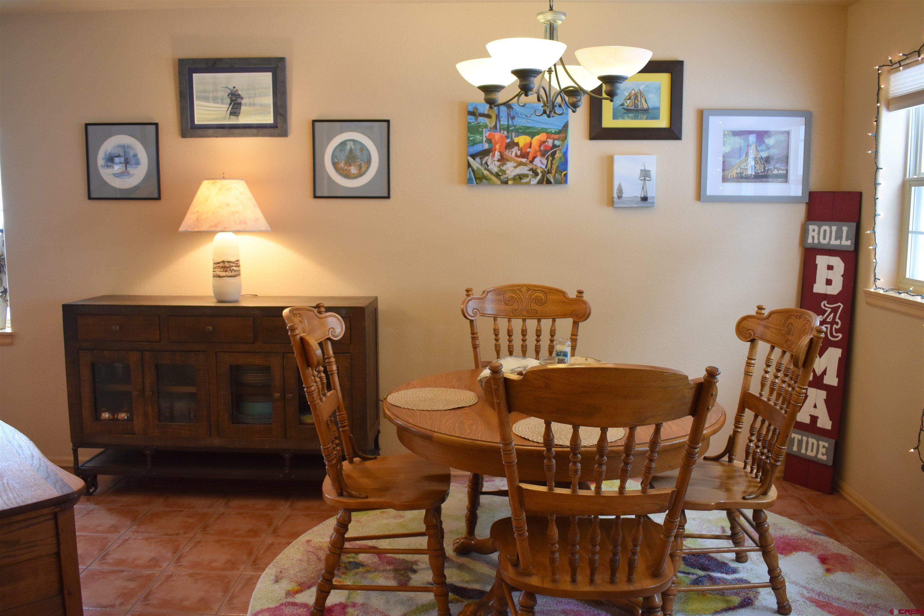 1570 Oak Street Ouray, CO 81427 - Photo 14 of 35 a view of a dining room with furniture and wooden floor