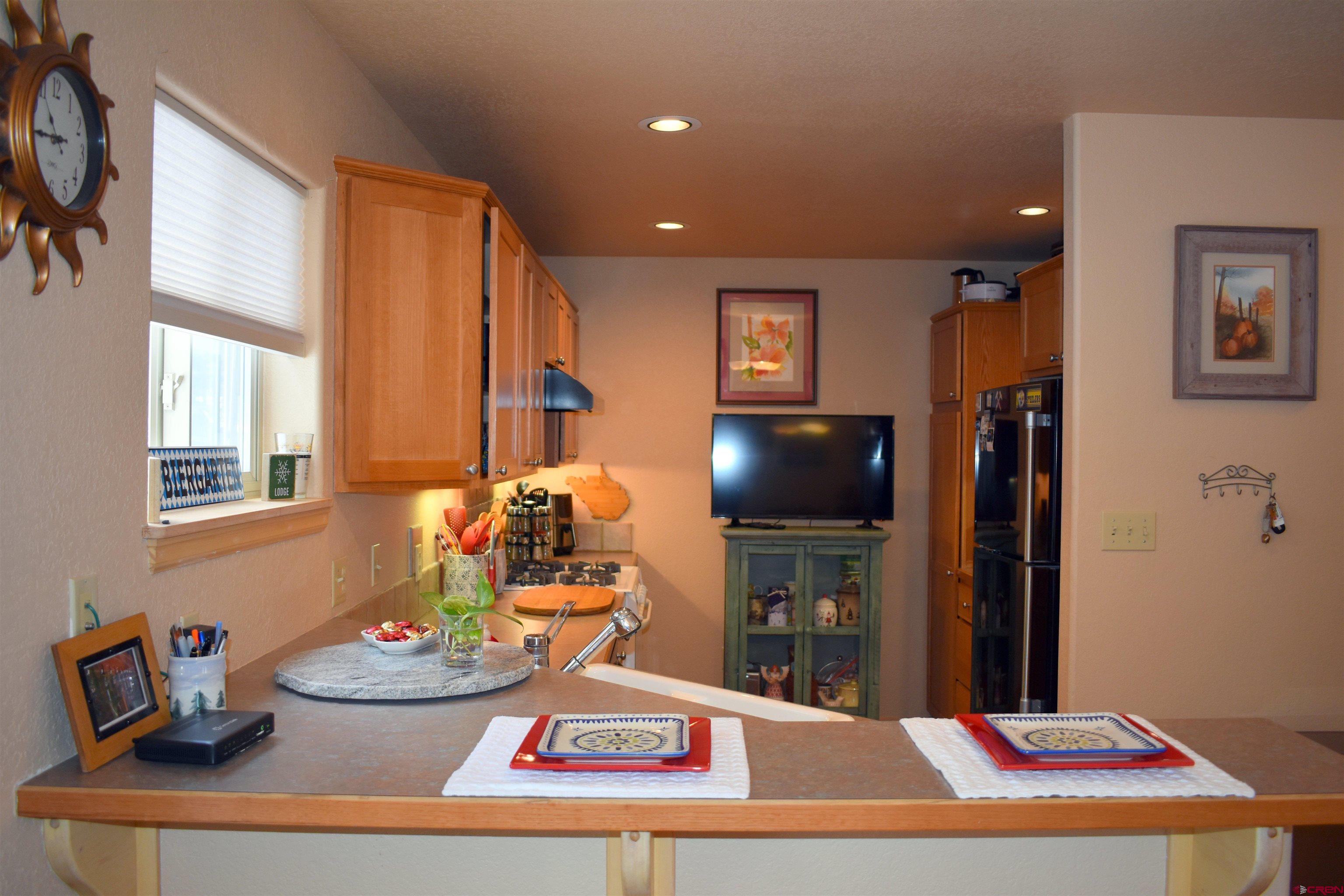 1570 Oak Street Ouray, CO 81427 - Photo 15 of 35 a living room with furniture and a flat screen tv