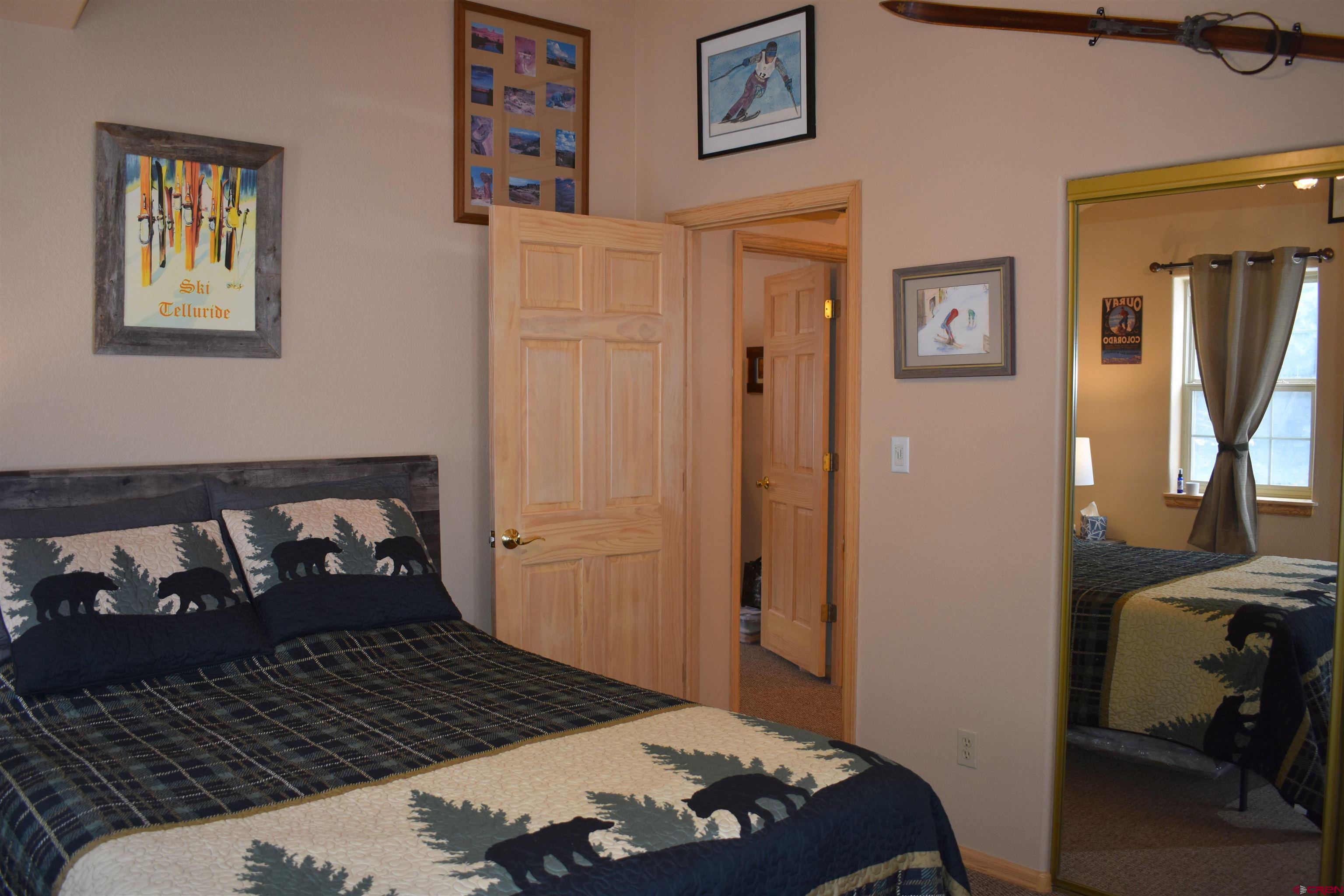 1570 Oak Street Ouray, CO 81427 - Photo 24 of 35 a bedroom with a bed and wooden floor