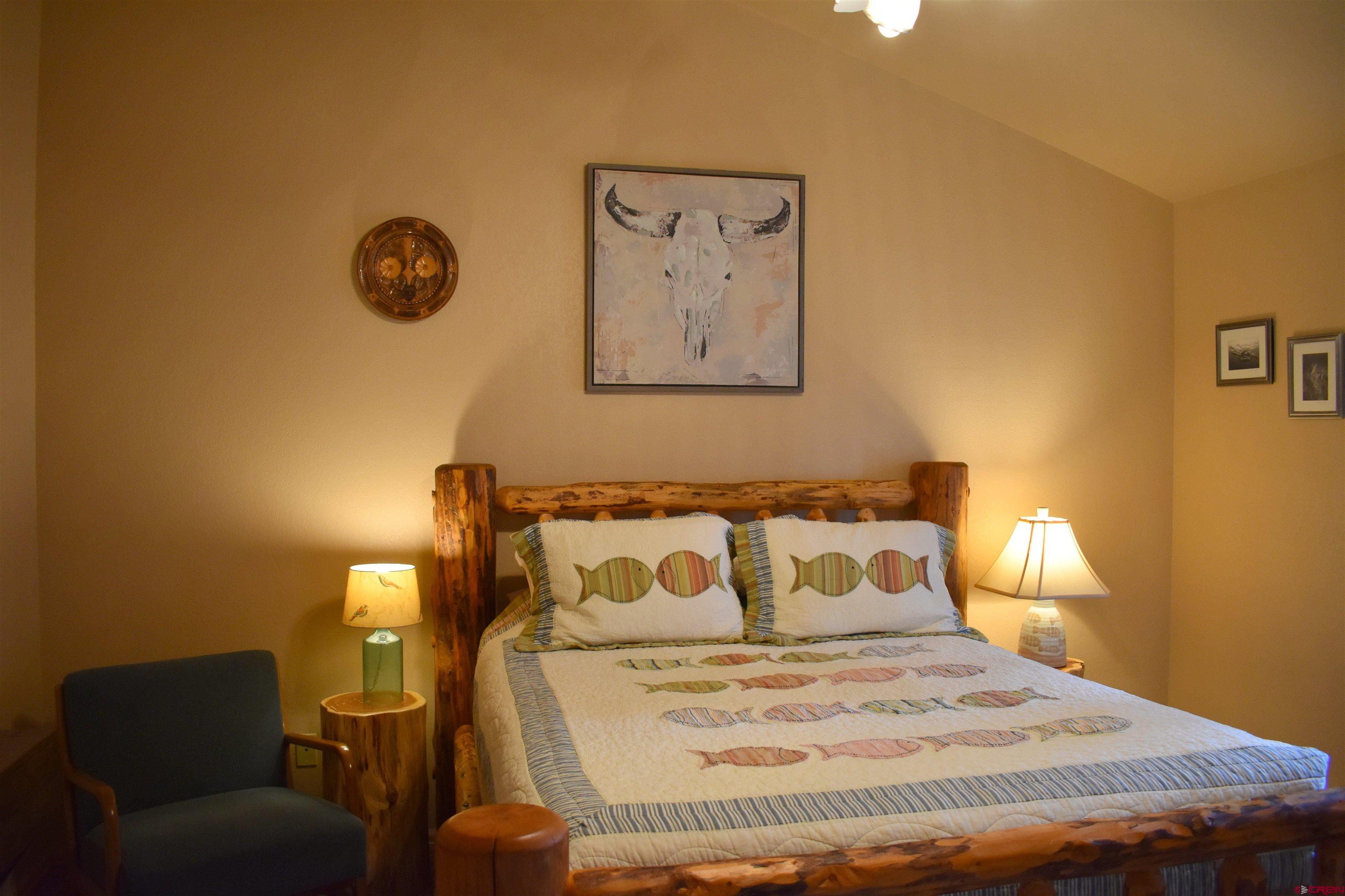 1570 Oak Street Ouray, CO 81427 - Photo 27 of 35 a bedroom with a bed and painting on the wall