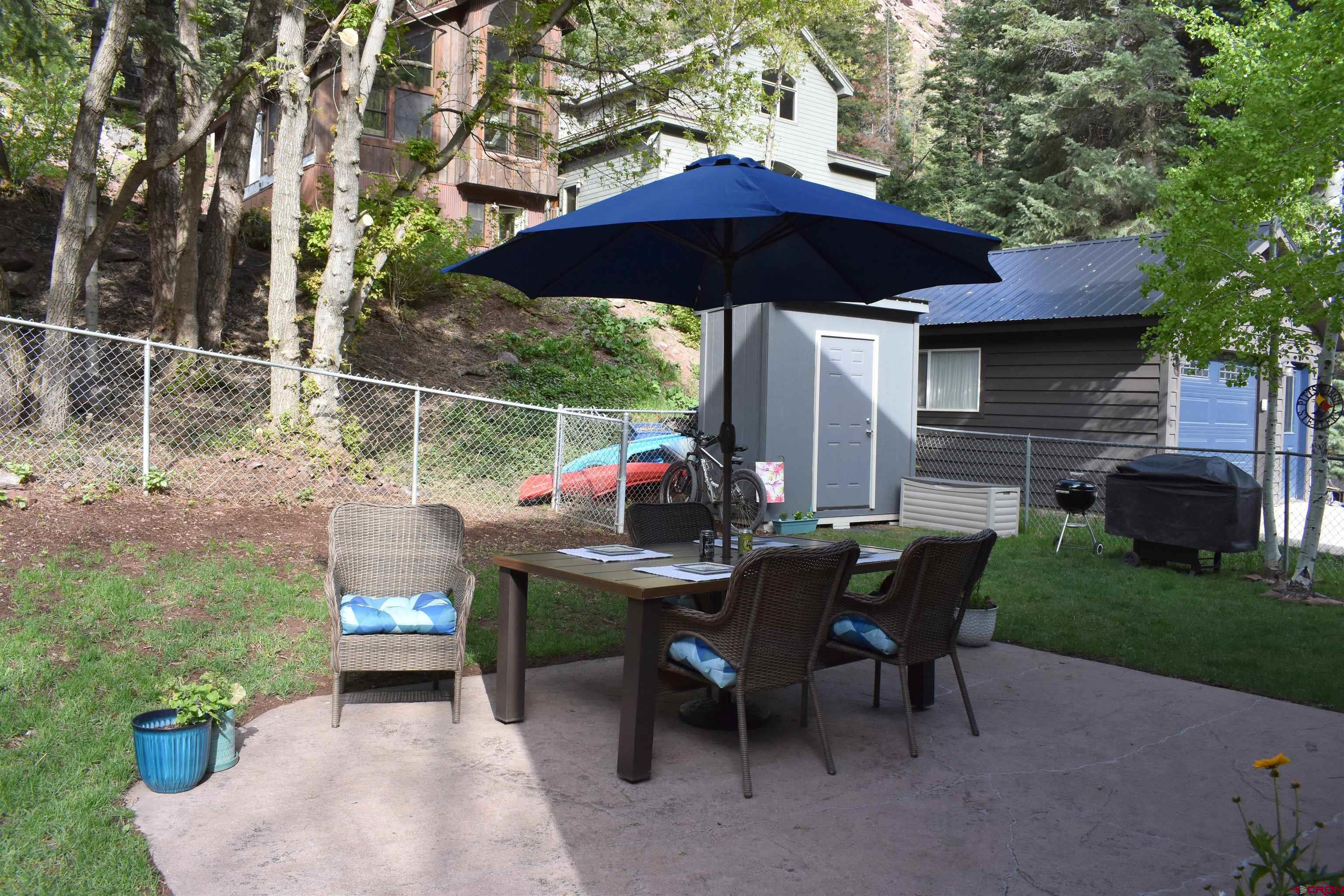 1570 Oak Street Ouray, CO 81427 - Photo 33 of 35 a view of backyard with seating space and trees