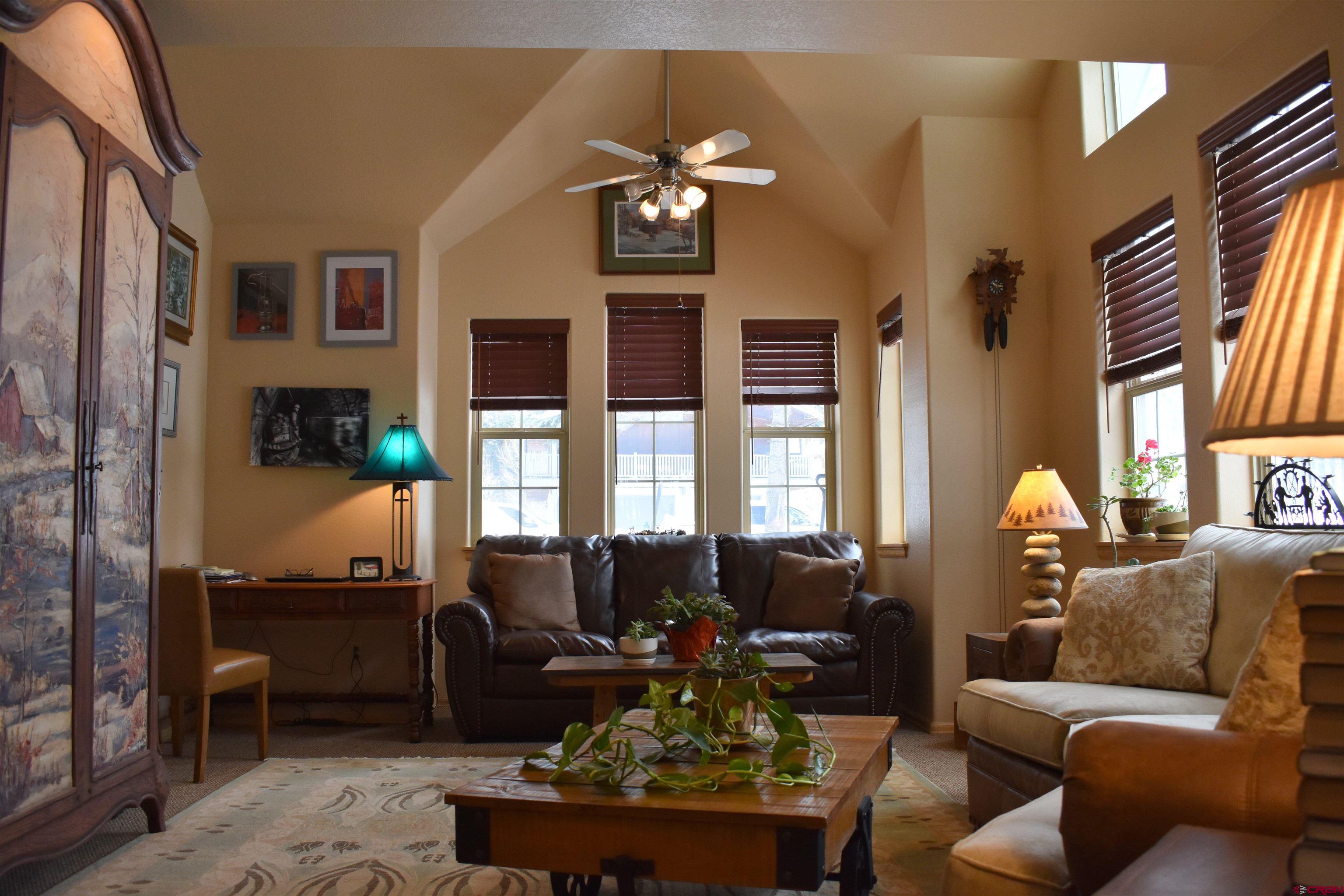 1570 Oak Street Ouray, CO 81427 - Photo 7 of 35 a living room with furniture a chandelier and a large window