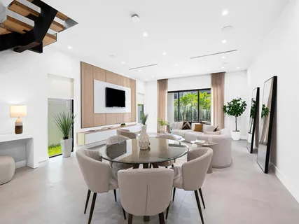 a living room with furniture and a wooden floor