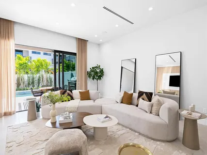 a view of a house with swimming pool and sitting area