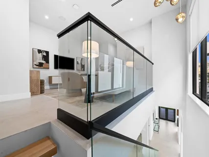 a living room with furniture a flat screen tv and a potted plant