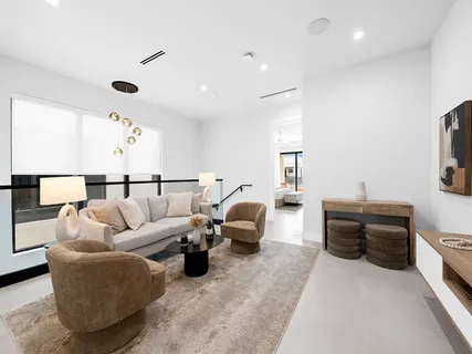 a bedroom with bed table and flat screen tv
