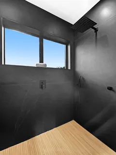 a spacious bedroom with a bed and a chandelier