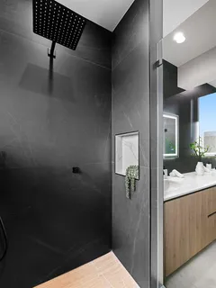a bathroom with a granite countertop sink toilet and shower