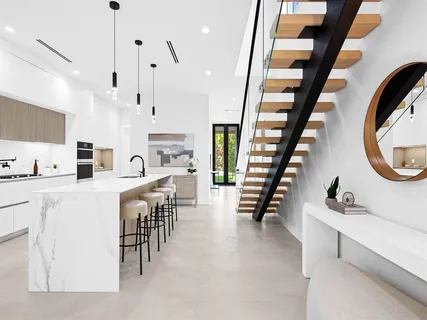 a large white kitchen with lots of counter space a sink and a large window