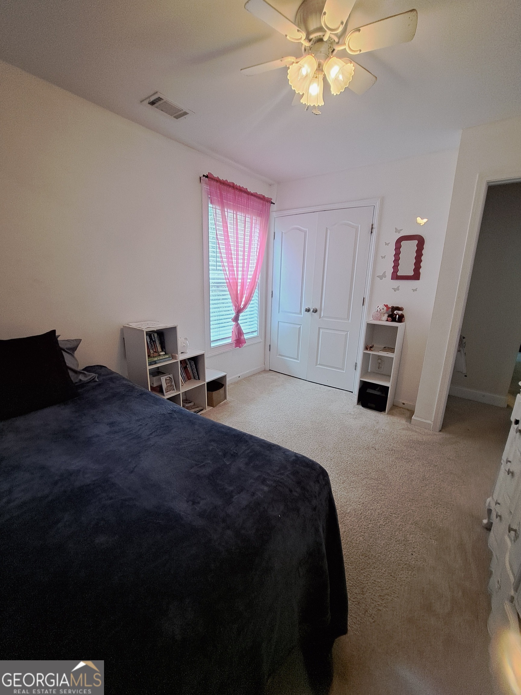 533 Edgewood Drive Athens, GA 30606 - Photo 15 of 20 a bedroom with a bed and a chandelier