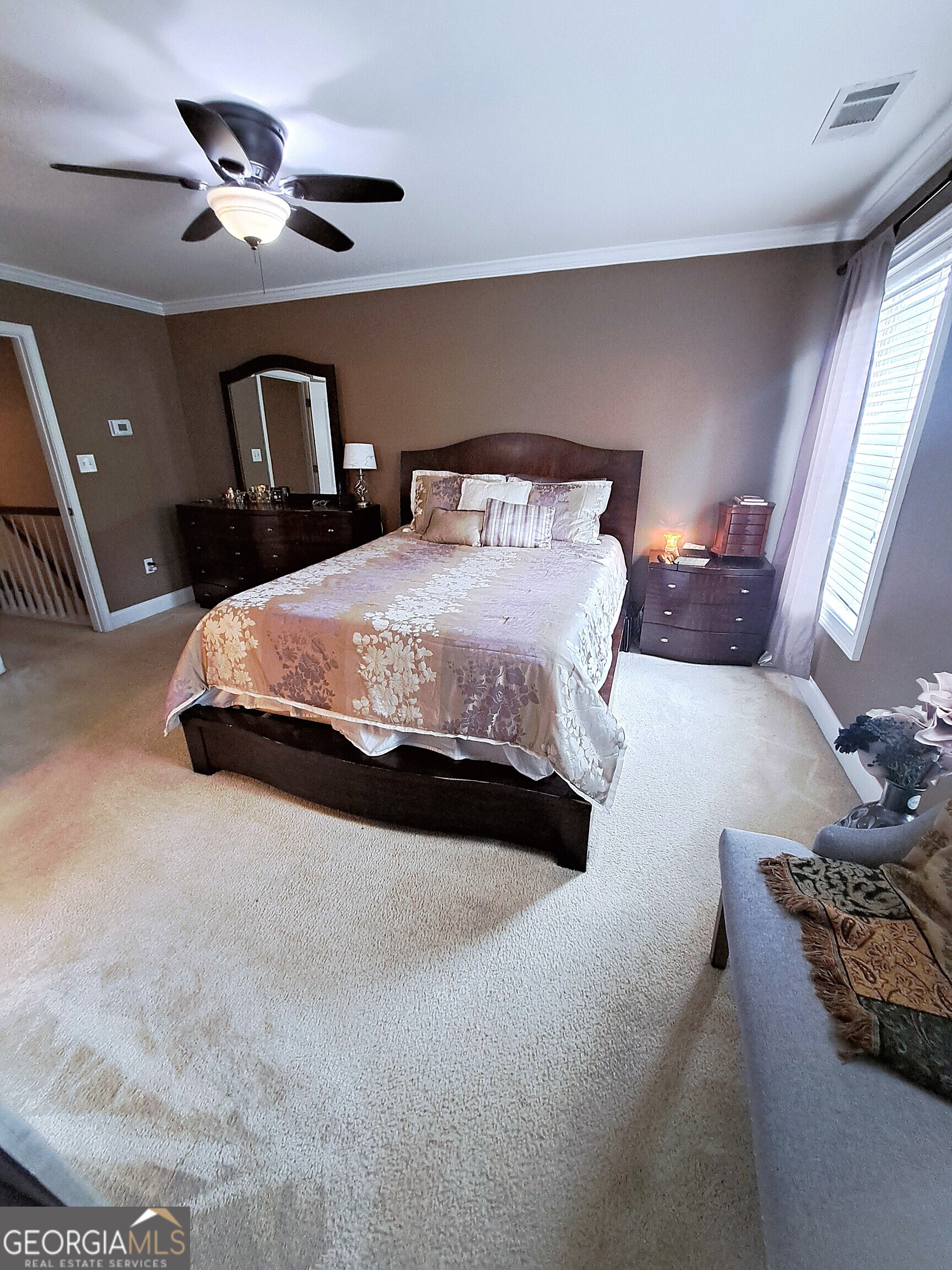 533 Edgewood Drive Athens, GA 30606 - Photo 10 of 20 a spacious bedroom with a bed and a chandelier