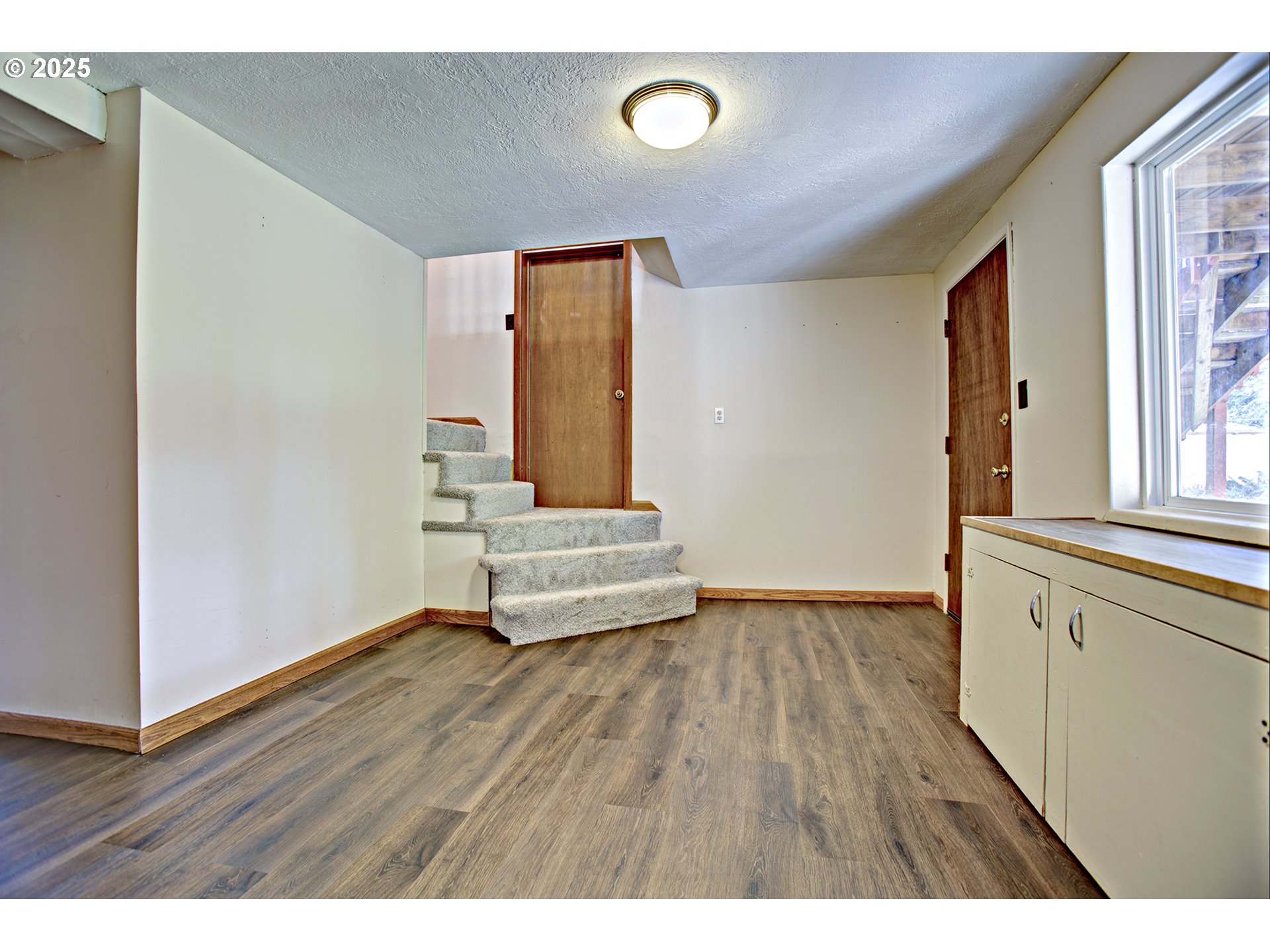 13633 Southeast 178th Avenue Damascus, OR 97089 - Photo 20 of 48 a view of an empty room with wooden floor and a window