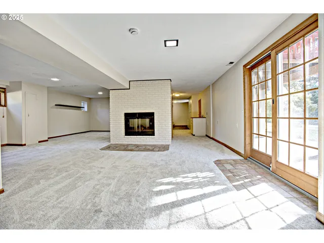 a view of a hallway with wooden floor and a fireplace