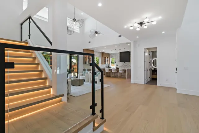 a view of hall way with furniture and chandelier