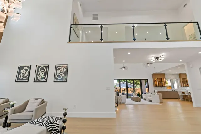 a kitchen with stainless steel appliances kitchen island a large counter top space and wooden floor