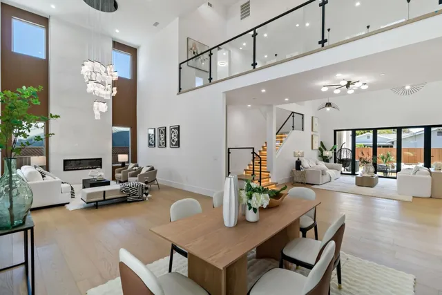 a living room with furniture wooden floor and a chandelier